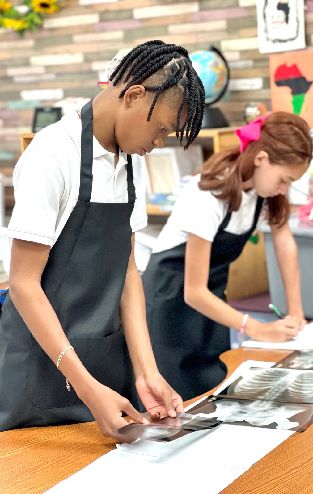 Students in aprons working at the table