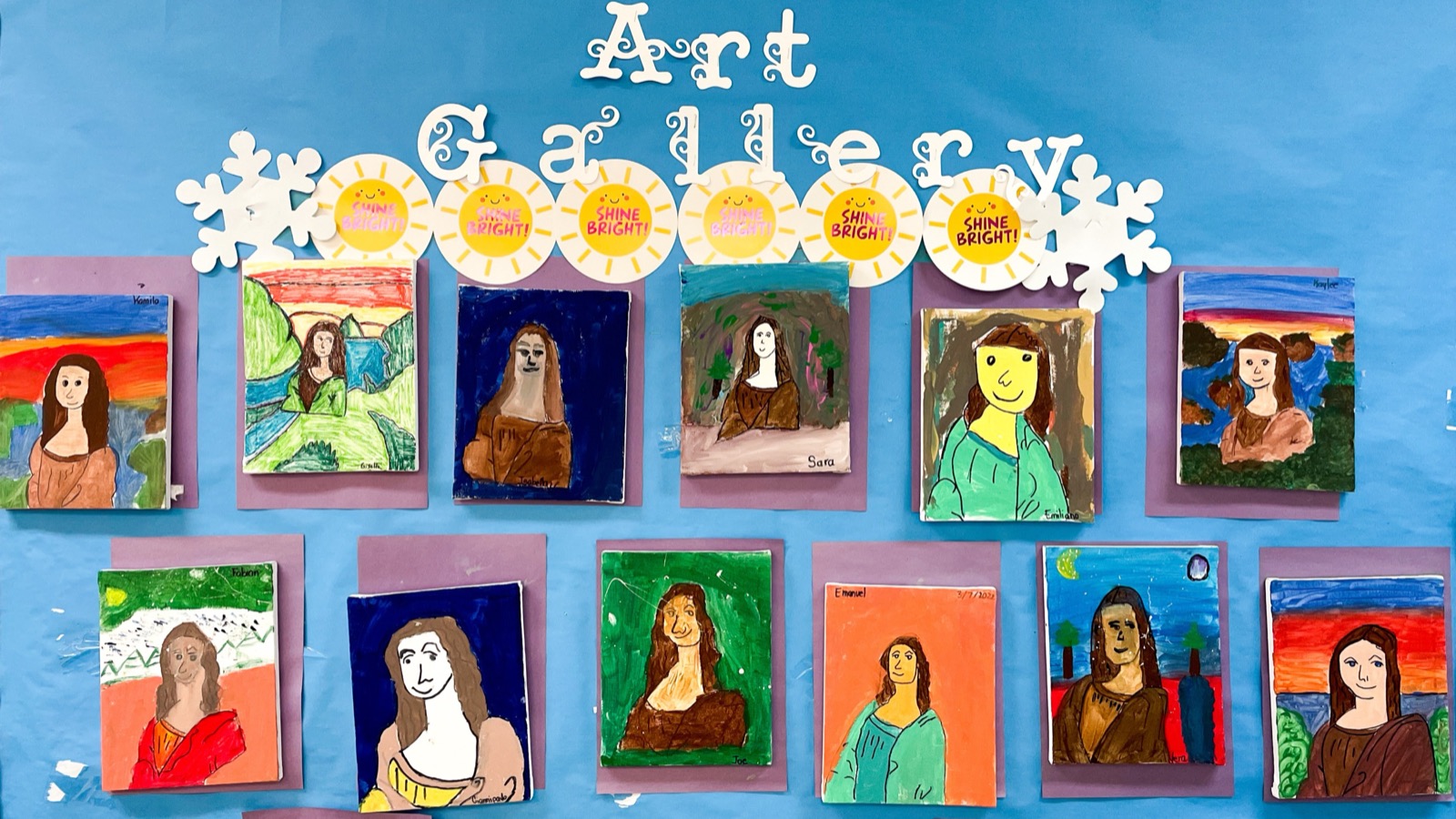 A classroom art gallery of student portraits