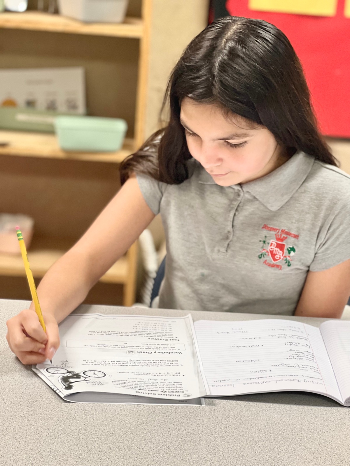 A student writing in a workbook
